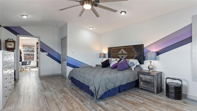 bedroom featuring a ceiling fan, baseboards, and wood finished floors