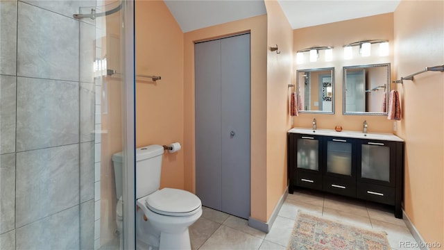 full bathroom featuring double vanity, a shower, toilet, tile patterned flooring, and a sink