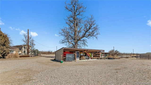 view of pole building featuring fence