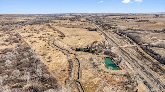 birds eye view of property featuring a rural view and a water view