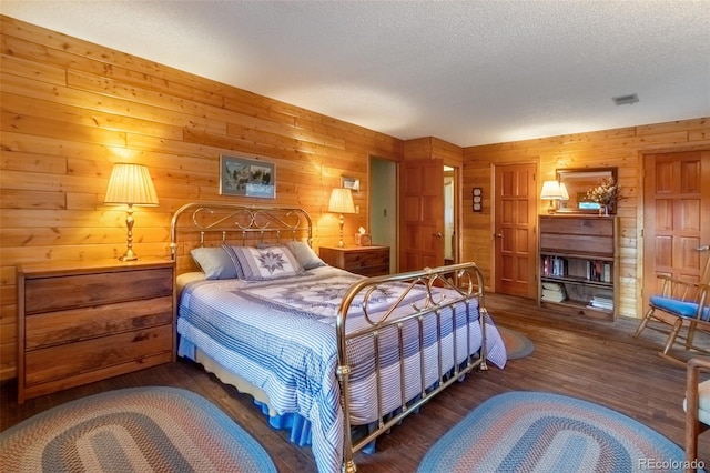 1295 Gcr 49, Grand Lake, CO 80447 - bedroom featuring wood finished floors, wood walls, and a textured ceiling