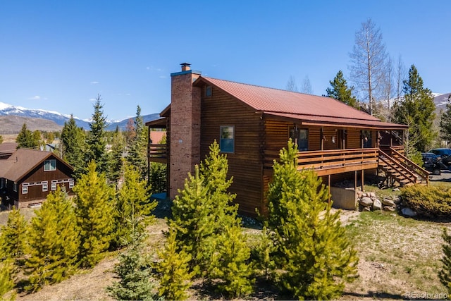 1295 Gcr 49, Grand Lake, CO 80447 - view of side of home with a chimney, a mountain view, and metal roof