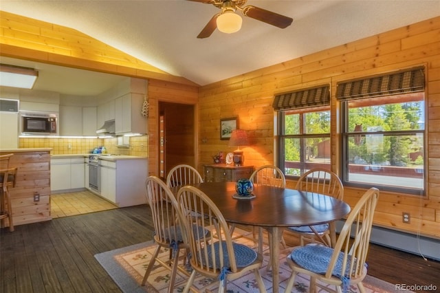 1295 Gcr 49, Grand Lake, CO 80447 - dining room featuring wooden walls, light wood-style flooring, vaulted ceiling, ceiling fan, and baseboard heating