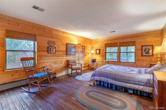 1295 Gcr 49, Grand Lake, CO 80447 - bedroom with wood-type flooring, wooden walls, a textured ceiling, and baseboards