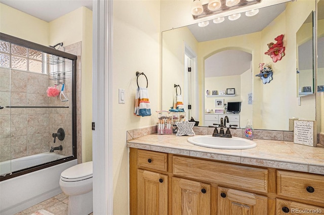 11065 W Rockland Dr, Littleton, CO 80127 - bathroom with vanity, toilet, and combined bath / shower with glass door