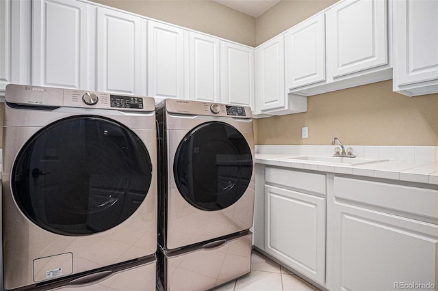 11065 W Rockland Dr, Littleton, CO 80127 - laundry room with separate washer and dryer, cabinet space, and light tile patterned floors