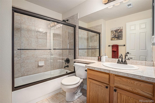 11065 W Rockland Dr, Littleton, CO 80127 - bathroom featuring toilet, vanity, enclosed tub / shower combo, and tile patterned flooring