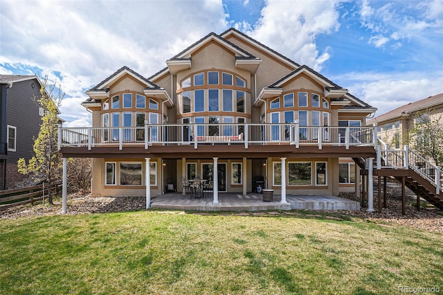 11065 W Rockland Dr, Littleton, CO 80127 - rear view of house with stucco siding, a patio area, a wooden deck, and stairs