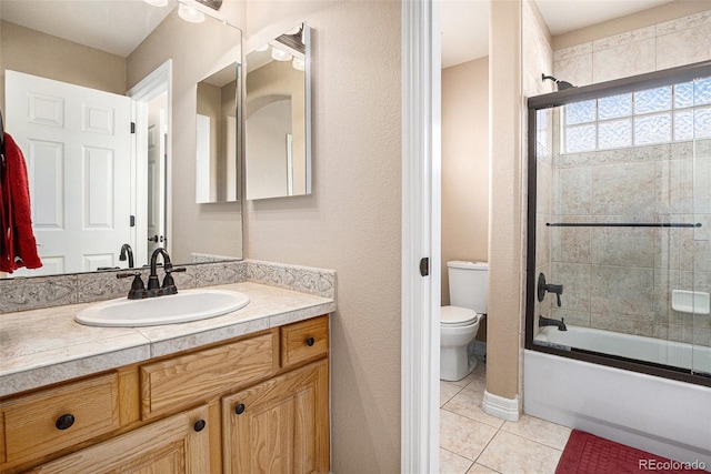 11065 W Rockland Dr, Littleton, CO 80127 - full bath with tile patterned floors, toilet, vanity, and bath / shower combo with glass door