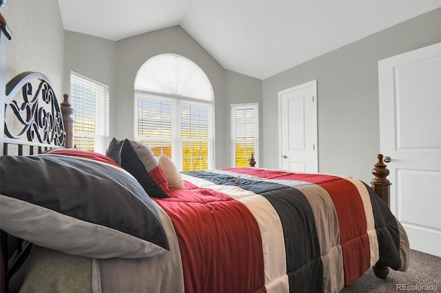 carpeted bedroom with vaulted ceiling