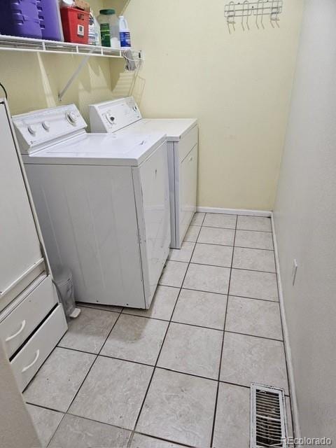 19939 Mitchell Cir, Denver, CO 80249 - laundry area with washer and dryer and light tile patterned floors