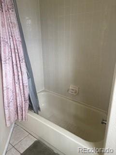 19939 Mitchell Cir, Denver, CO 80249 - full bath featuring tile patterned floors and shower / bath combo with shower curtain