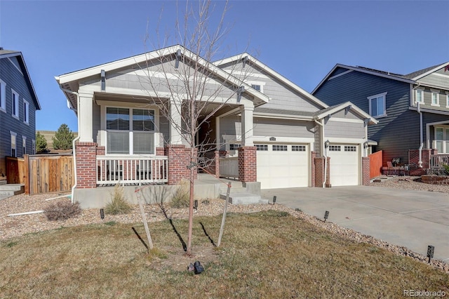 craftsman-style home featuring a garage, covered porch, and a front lawn