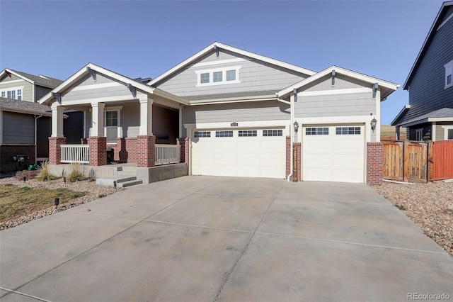 craftsman inspired home featuring a porch and a garage