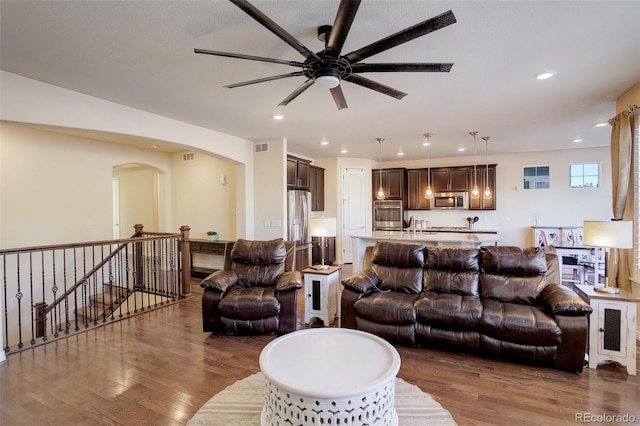 living room featuring ceiling fan and hardwood / wood-style flooring