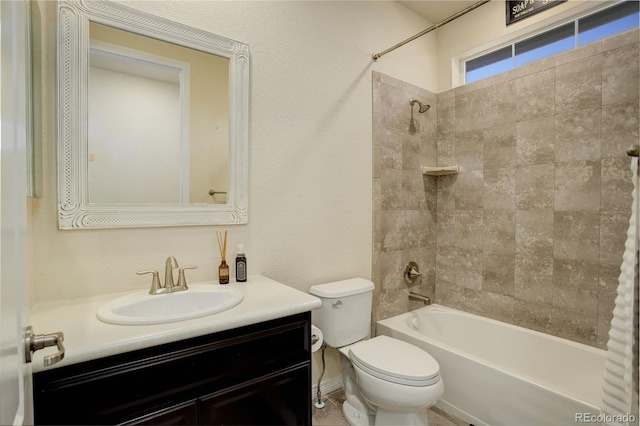 full bathroom with tiled shower / bath combo, toilet, and vanity