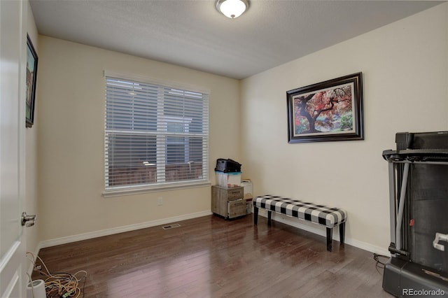 miscellaneous room featuring a textured ceiling and dark hardwood / wood-style floors