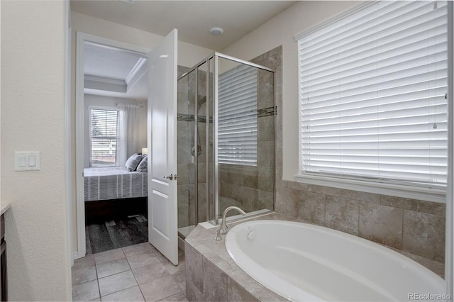 bathroom featuring tile patterned flooring, shower with separate bathtub, and vanity