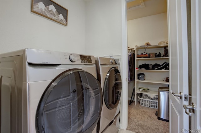 washroom with washer and clothes dryer and light colored carpet