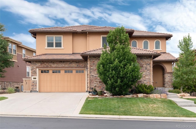 10783 Skydance Dr, Highlands Ranch, CO 80126 - mediterranean / spanish-style house featuring stone siding, a garage, a tiled roof, driveway, and a front yard