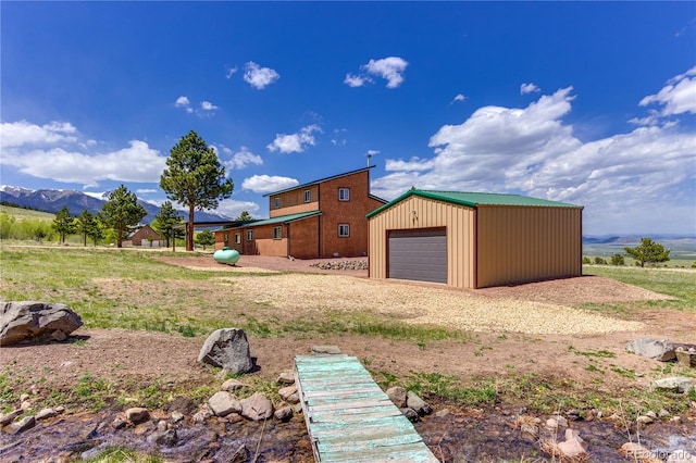 62 Rubel Cir, Westcliffe, CO 81252 - view of home's exterior with an outbuilding, driveway, a mountain view, and a detached garage