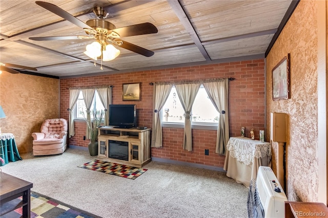 62 Rubel Cir, Westcliffe, CO 81252 - carpeted living room with wood ceiling with exposed beams, a ceiling fan, heating unit, and brick wall