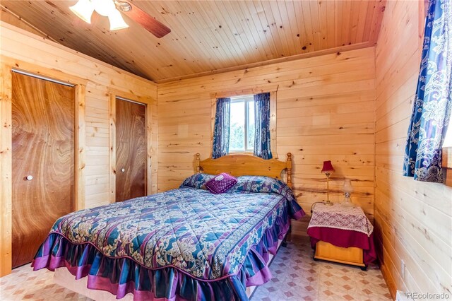 62 Rubel Cir, Westcliffe, CO 81252 - bedroom featuring wooden walls, tile patterned floors, wooden ceiling, and ceiling fan