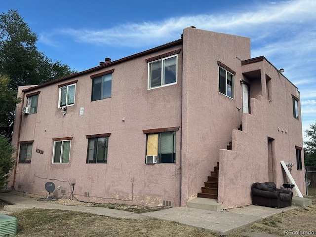 rear view of house featuring cooling unit