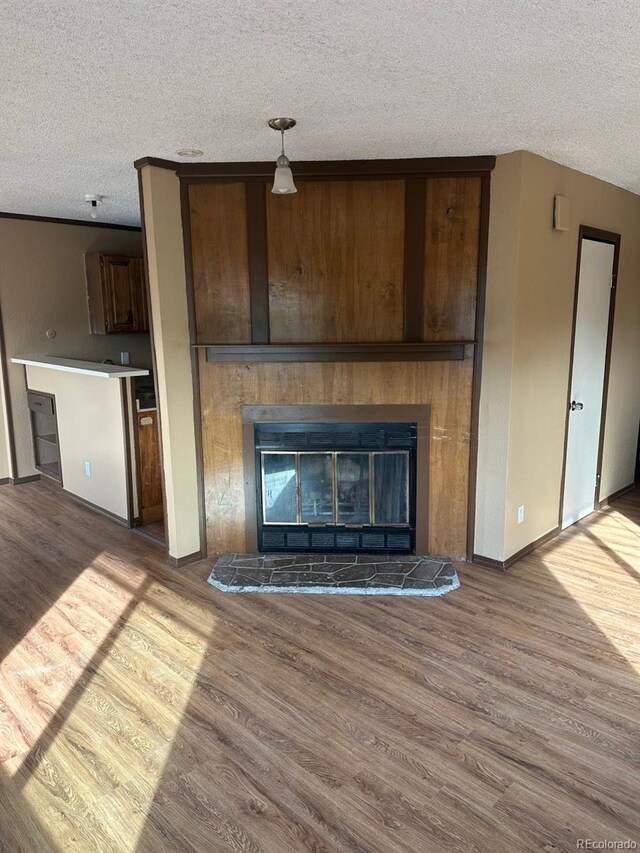 unfurnished living room with a textured ceiling and hardwood / wood-style flooring