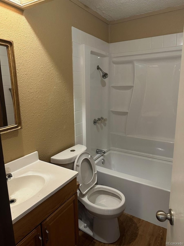 full bathroom featuring a textured ceiling, toilet, shower / bath combination, vanity, and hardwood / wood-style flooring