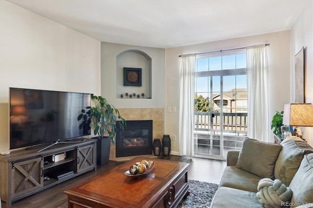 living room featuring a tiled fireplace