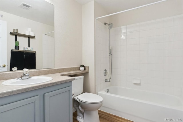 full bathroom featuring toilet, vanity, washtub / shower combination, and hardwood / wood-style floors