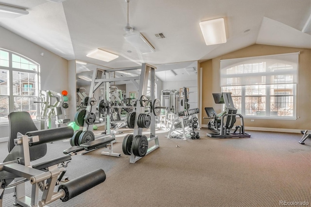 exercise room with ceiling fan and vaulted ceiling