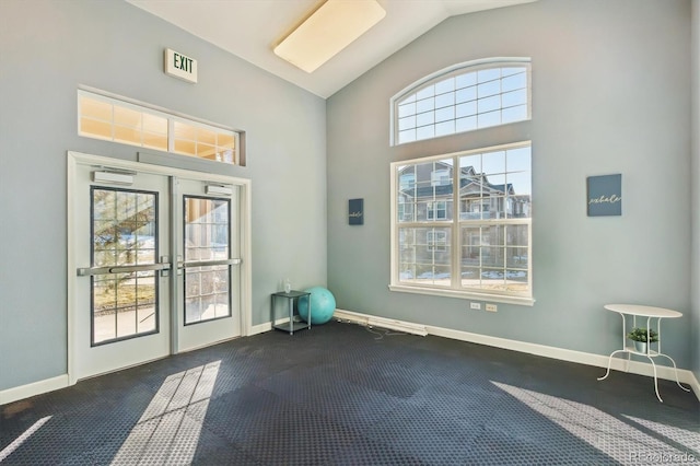 entryway featuring lofted ceiling and french doors