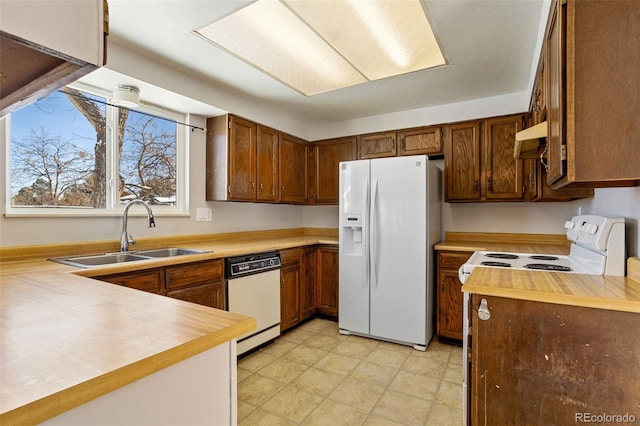 kitchen featuring sink and white appliances