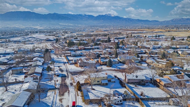 snowy aerial view with a mountain view