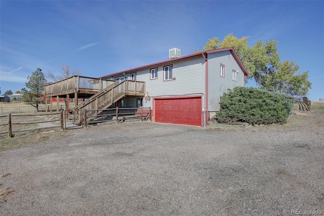 view of front facade featuring a deck and a garage