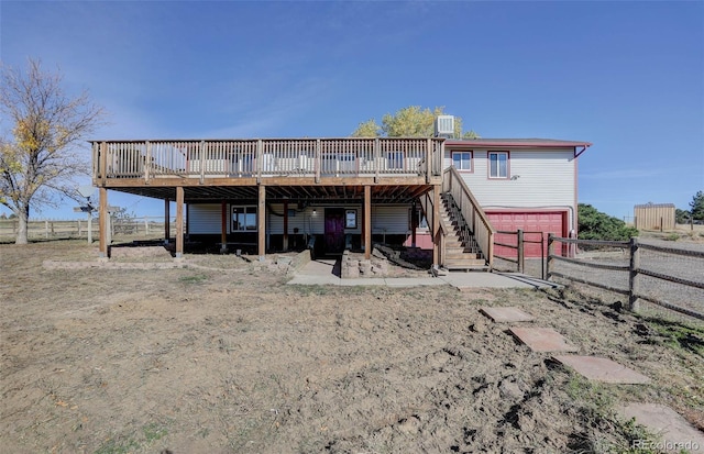 rear view of house featuring a deck