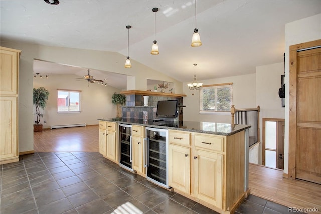 kitchen featuring baseboard heating, dark wood-type flooring, dark stone countertops, vaulted ceiling, and beverage cooler