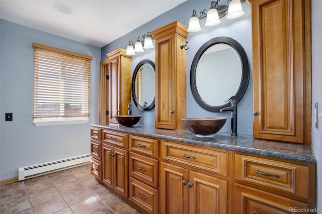 bathroom with vanity, a baseboard heating unit, and tile patterned flooring