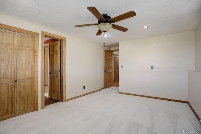 unfurnished bedroom with ceiling fan, carpet, and a textured ceiling