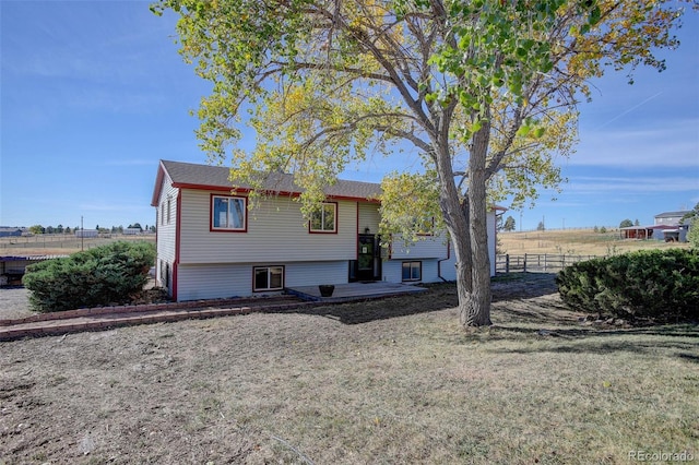 view of front of house with a front yard and a deck