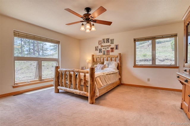 bedroom with ceiling fan and light carpet