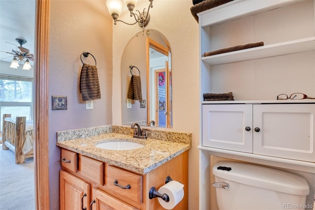 bathroom featuring ceiling fan, toilet, and vanity