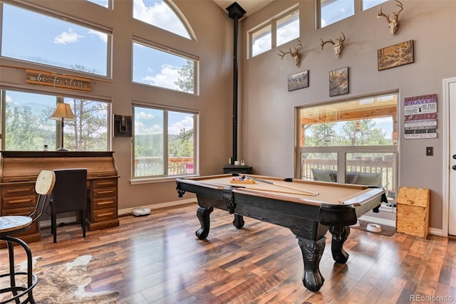 rec room featuring hardwood / wood-style flooring, a high ceiling, and billiards