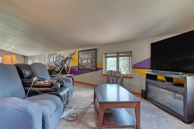 carpeted living room with lofted ceiling