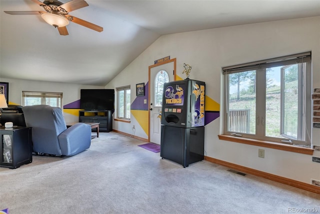 living room featuring ceiling fan, lofted ceiling, light carpet, and a wealth of natural light