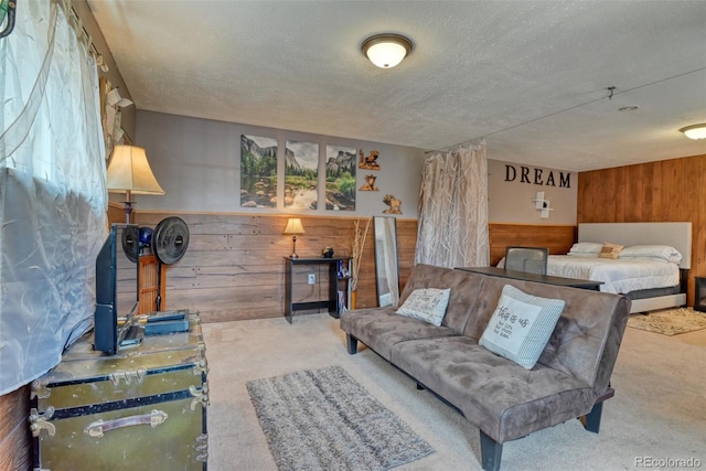 carpeted living room with wooden walls and a textured ceiling