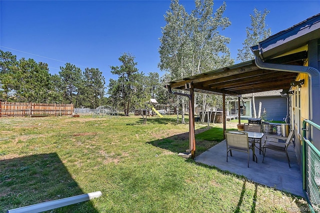 view of yard featuring a patio and a playground