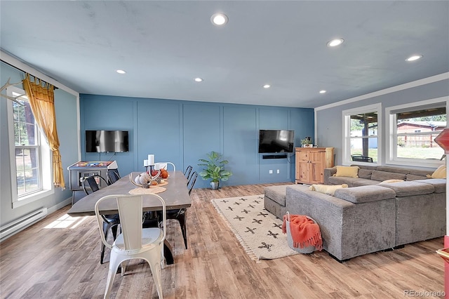 living room with light hardwood / wood-style floors and crown molding